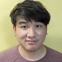 Arno Plan has short dark hair.