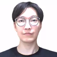Dr Yoo has short black hair and glasses