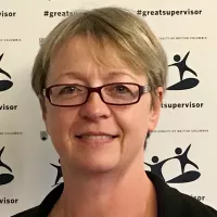 Dr Gregory Evans has short blond hair and glasses.