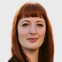 Dr. Carr has shoulder length red hair and she is smiling.